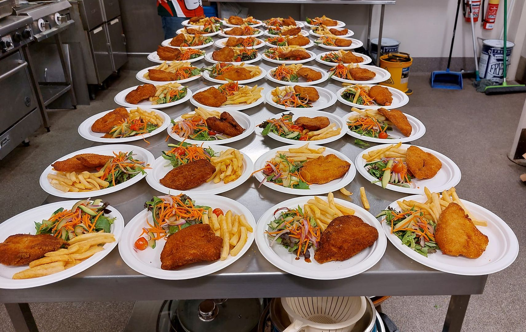 Many White Plates With Breaded Cutlets, Fries, and Salad — Tre's Food To You in Mount Sheridan, QLD