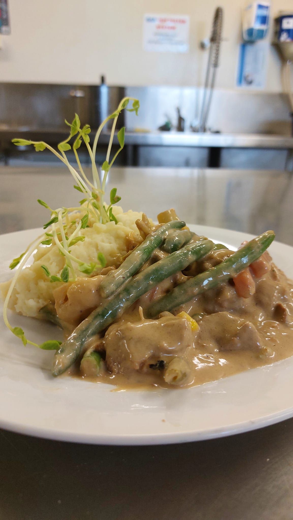 A Plate of Creamy Chicken With Green Beans and Mashed Potatoes — Tre's Food To You in Mount Sheridan, QLD