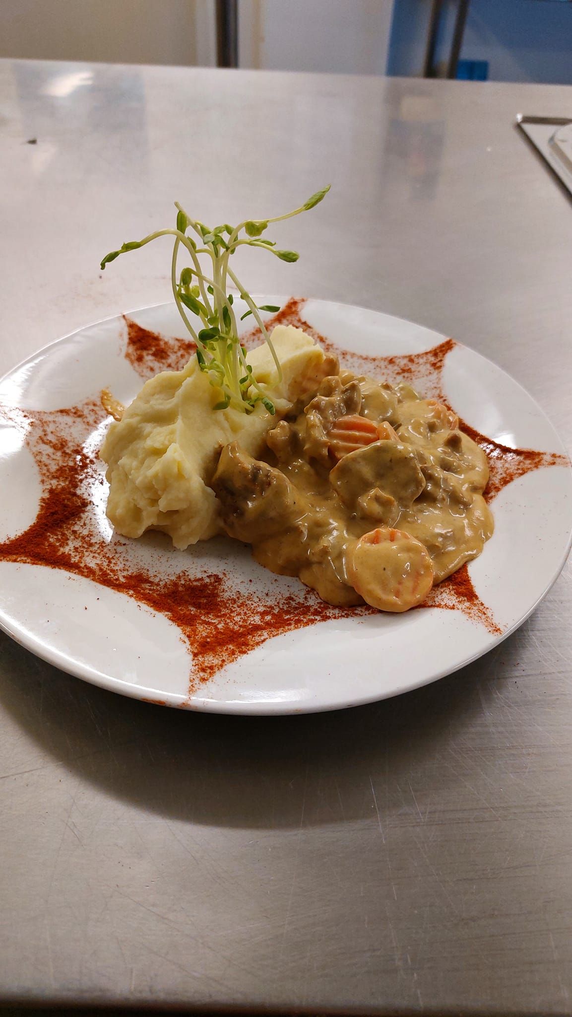 A Plate of Creamy Beef Stew Served With Mashed Potatoes, Garnished With Herbs — Tre's Food To You in Mount Sheridan, QLD