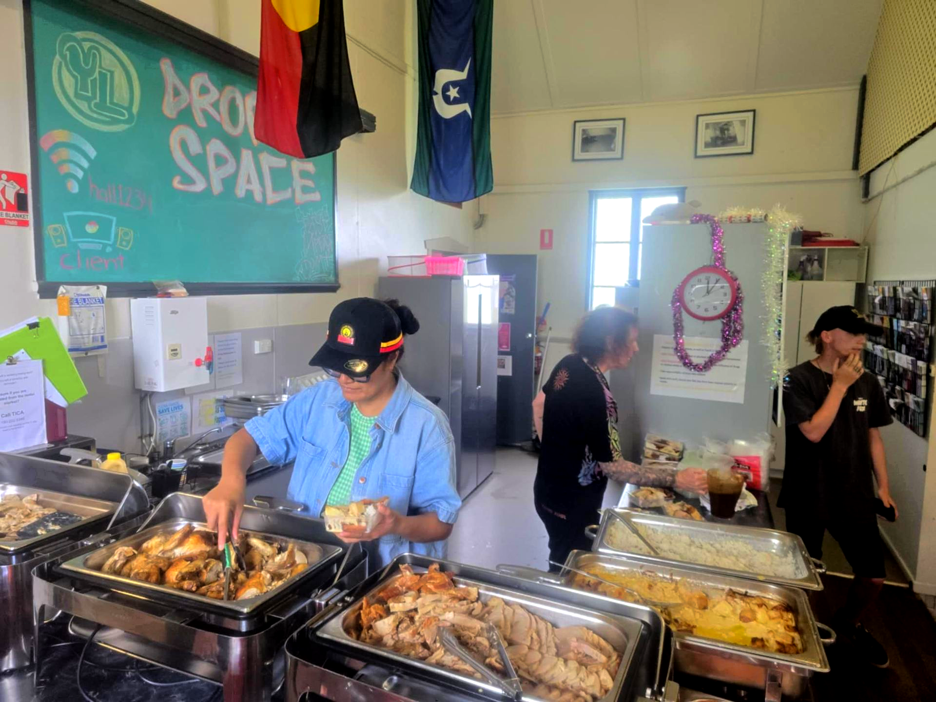 People Serve Food From Buffet Trays in a Community Center Space — Tre's Food To You in Mount Sheridan, QLD