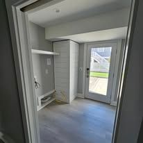 Interior doorway with a view of a storage area and an exterior door.
