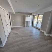 Empty room with light gray flooring and white walls.