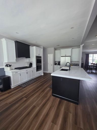 A kitchen with white cabinets and stainless steel appliances