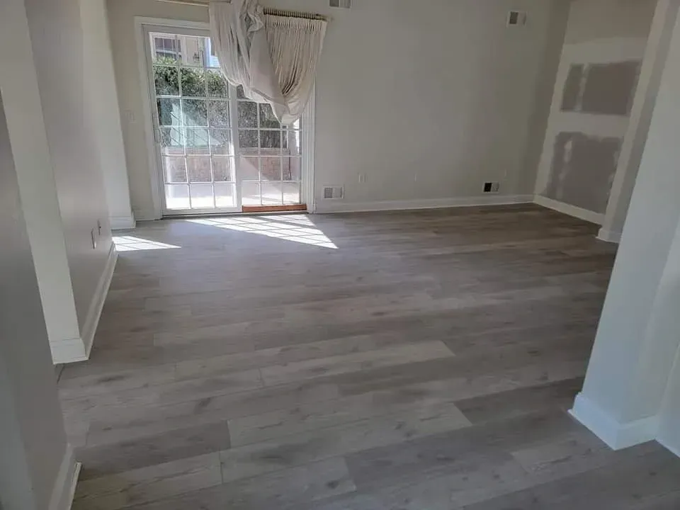 A living room with hardwood floors and a sliding glass door.