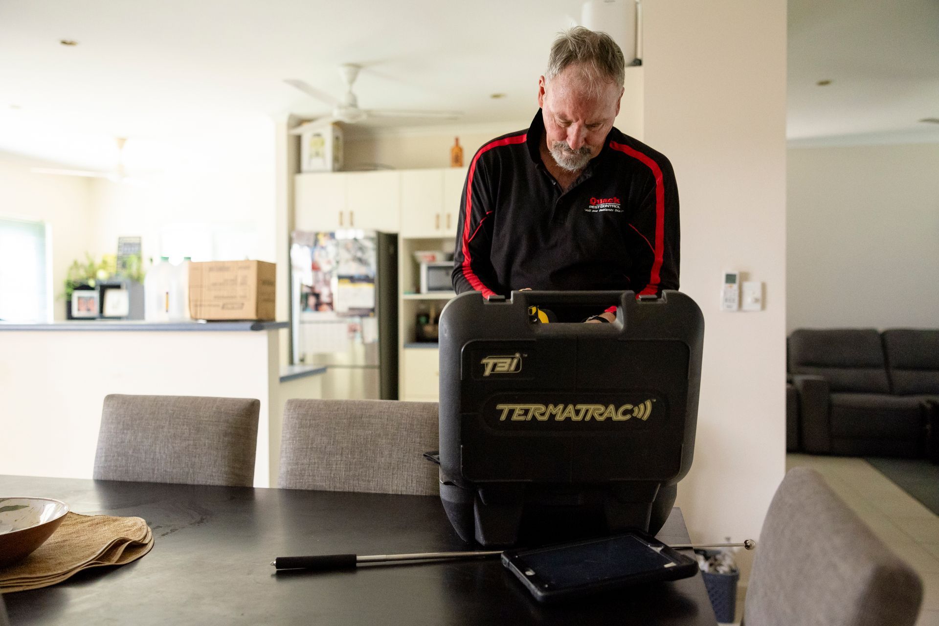 A Man Looking Into Case Of Pest Tool — Quack Pest Control in Coolalinga, NT