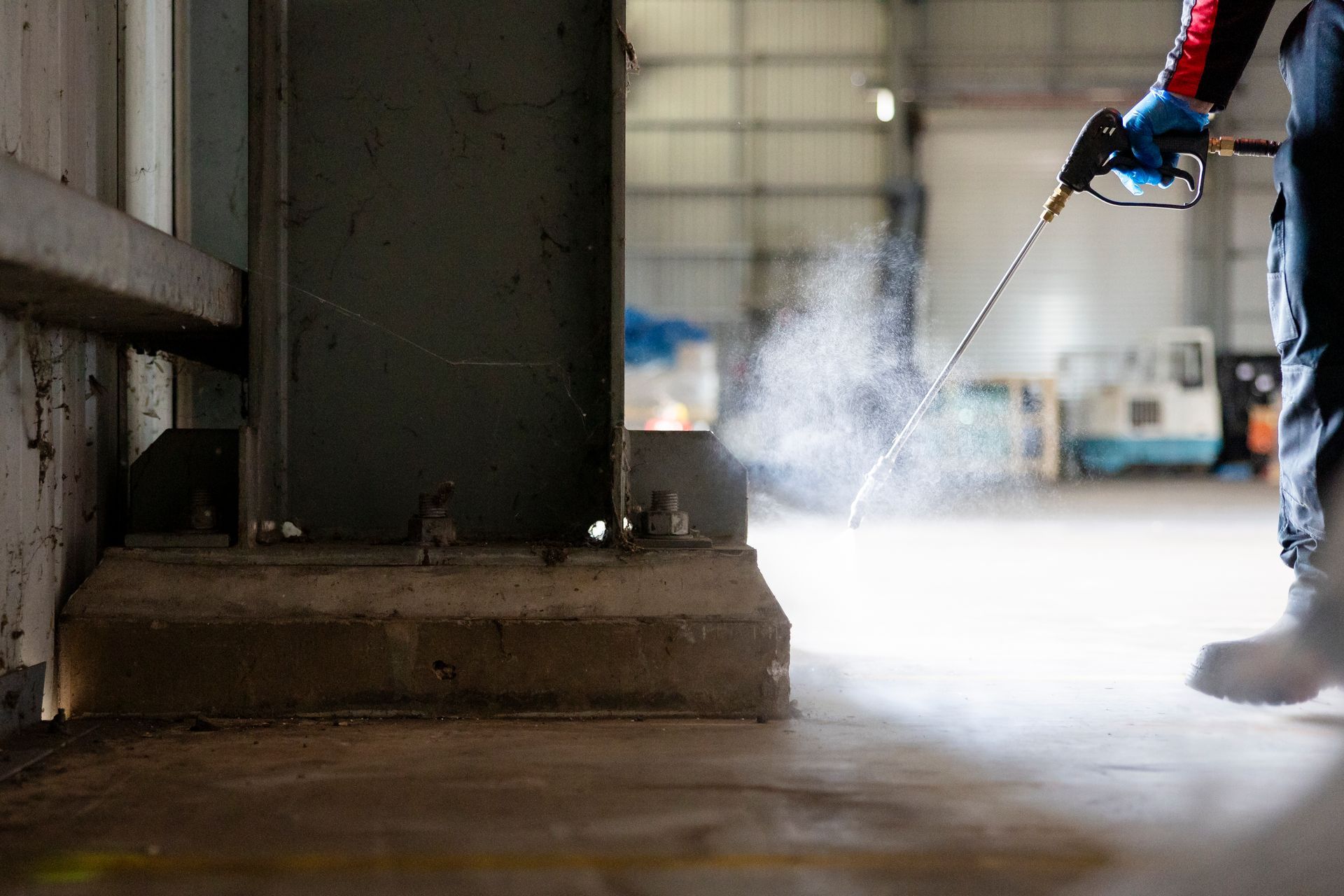 A Man Spraying Pest Control In Commercial Warehouse — Quack Pest Control in Winnellie, NT