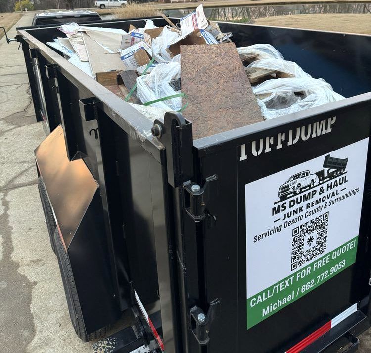 A dumpster with a sign that says MS Dump & Haul on it