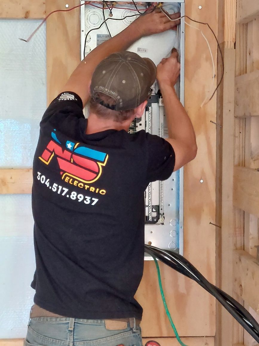 NS Electric technician performing interior panel work on residential property