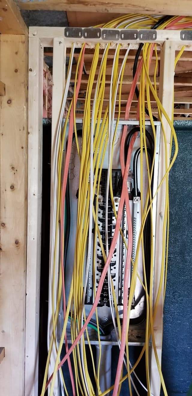 Commercial office breakers being wired by NS Electric electricians