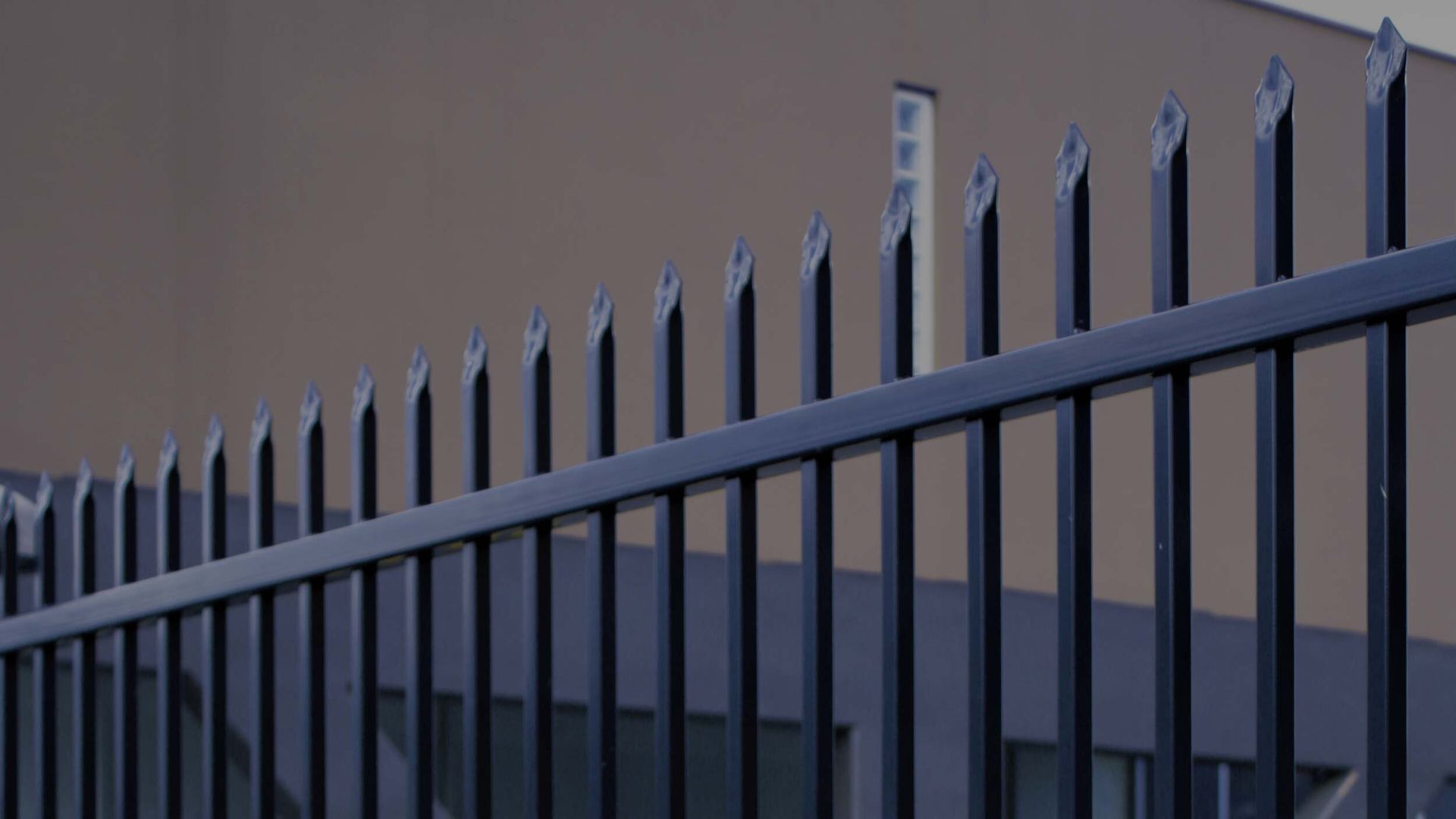 A Close up Of a Metal Fence in Front of A Building — Byron & Beyond Fencing In Billinudgel, NSW