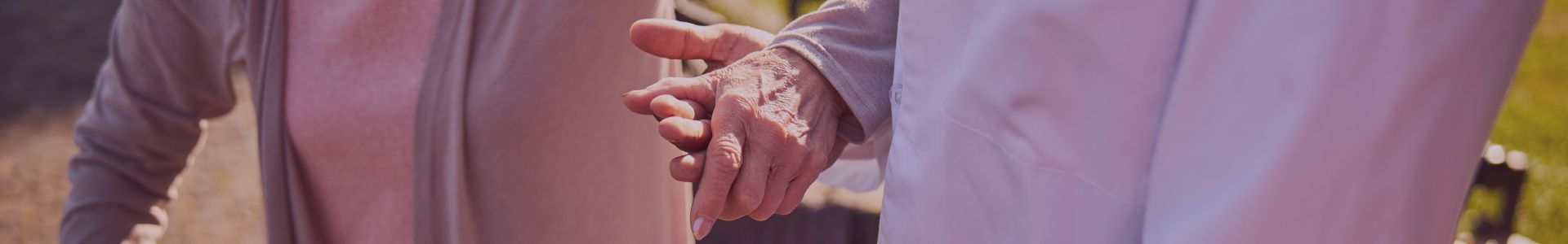 A couple of people are holding hands while standing next to each other.