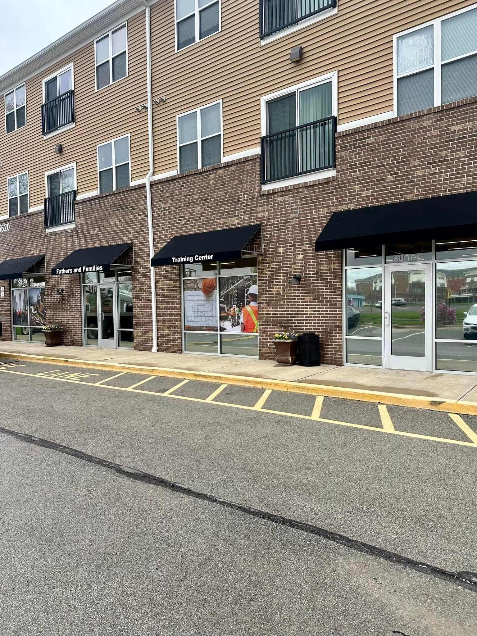 Pharmacy facade with large green signage, window displays, and a pharmacy cross.