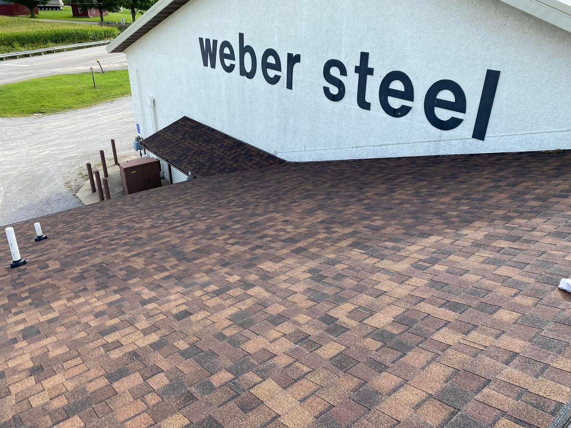A weber steel sign is painted on the side of a building