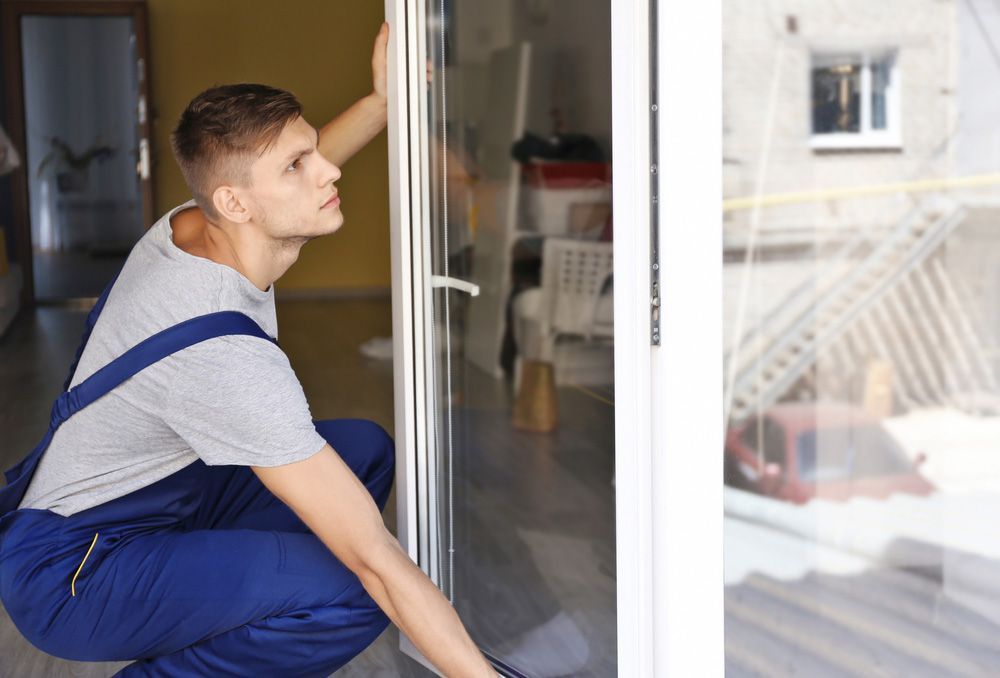 Construction Worker Installing Window In House — Glass Repairs & Installations in Quirindi, NSW