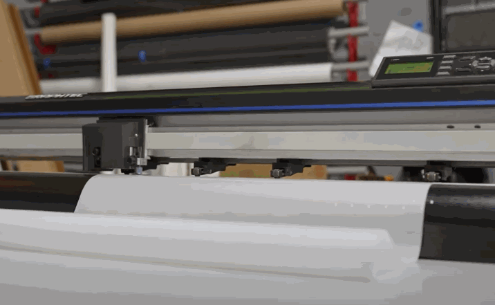 Precision machine cutting sheets of paint protection film to fit a specific vehicle design.