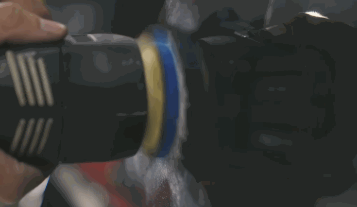 A machine buffer is used to polish a vehicle's surface after ceramic coating, creating a smooth, high-gloss finish.