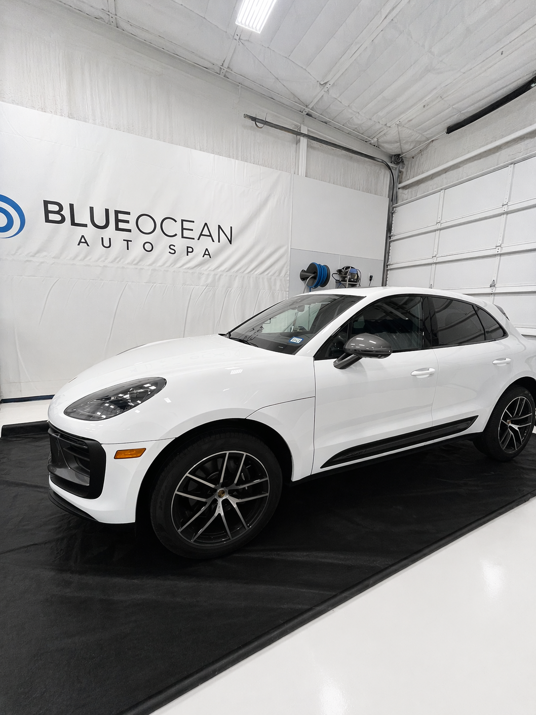 A 2025 Porsche Macan just arrived at Blue Ocean Auto Spa of Cedar Park Tx and is pictured here in our indoor wash bay and about to receive our paint decontamination prep.