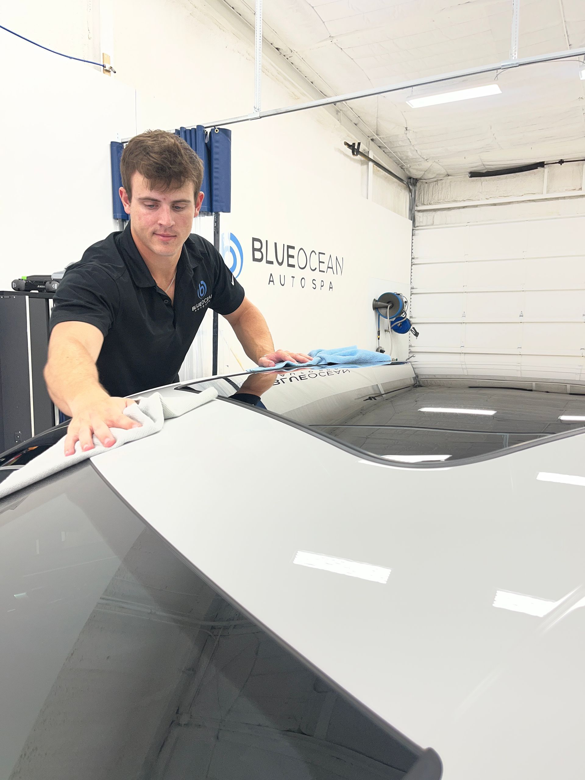 A Blue Ocean Auto Spa ceramic coating technician applying a professional ceramic coating to this 2025 Porsche Macan.