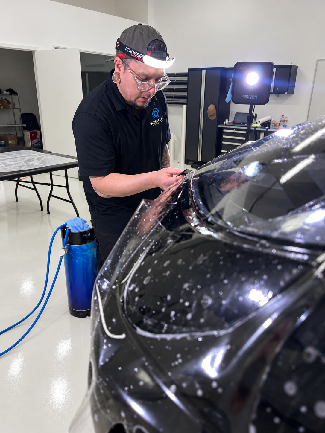 Close-up of XPEL paint protection film installation on a Corvette Stingray front bumper