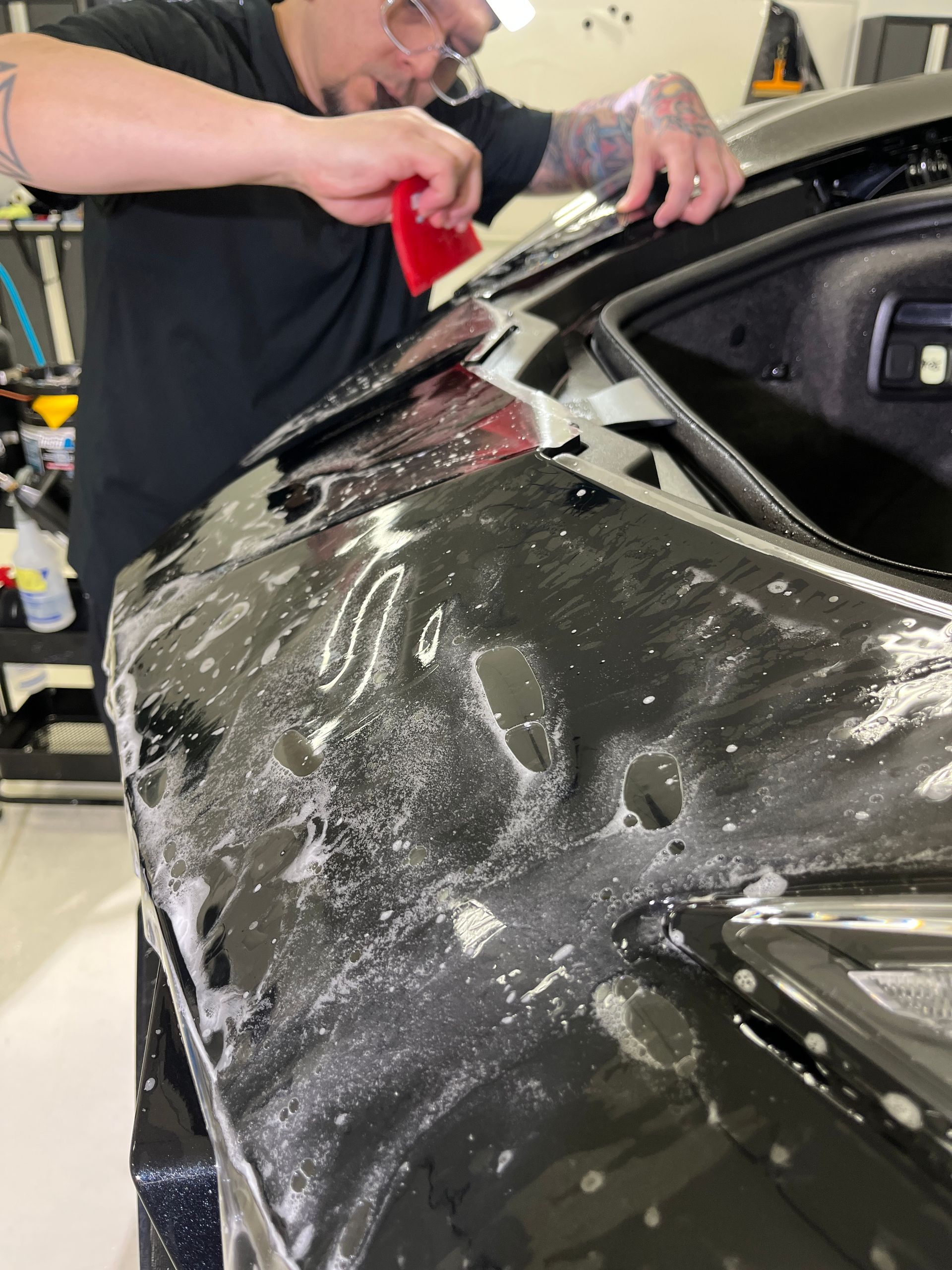 Blue Ocean Auto Spa technician installing XPEL PPF on a Corvette Stingray