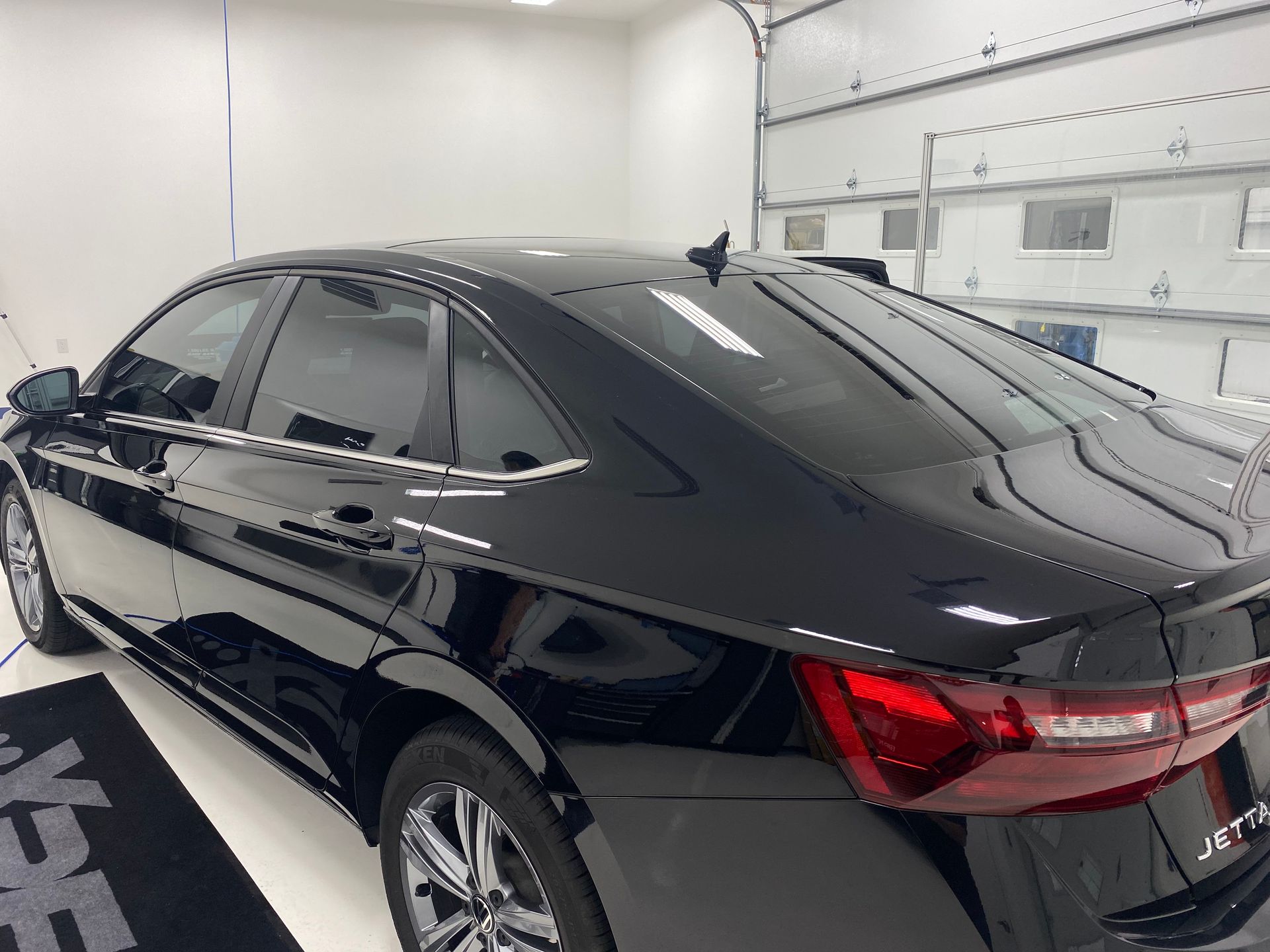 A black car is parked in a garage.