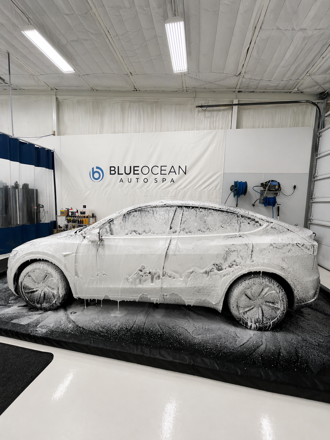 Trapped air and slip solution are removed from the PPF layer to ensure full clarity and maximum paint protection. Thick foam wash during the detailing process on this Tesla Model Y. Proper prep is critical before ceramic coating to ensure maximum bonding and long-term durability.