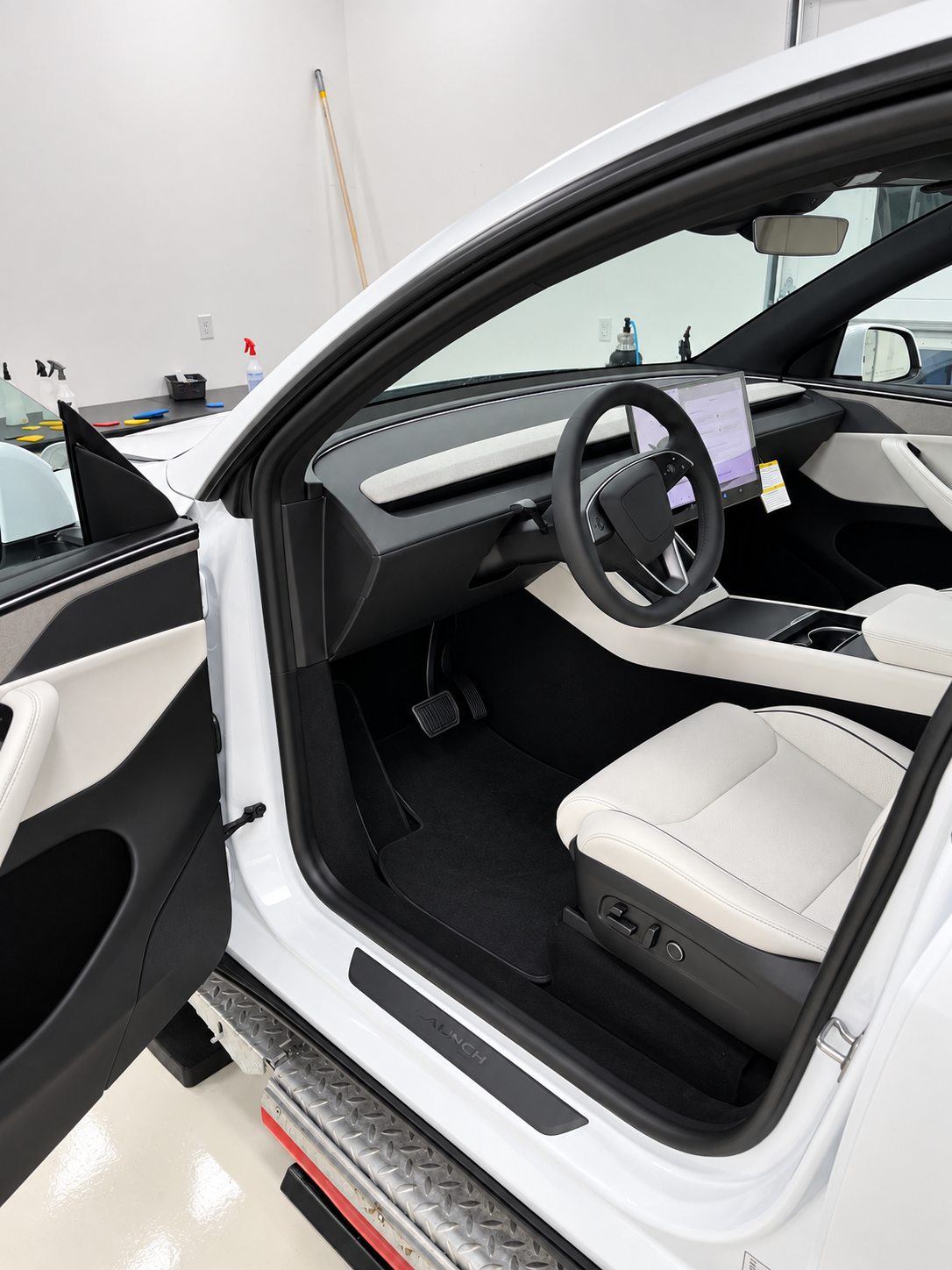 Front interior and center display of 2027 Tesla Model Y L at Blue Ocean Auto Spa