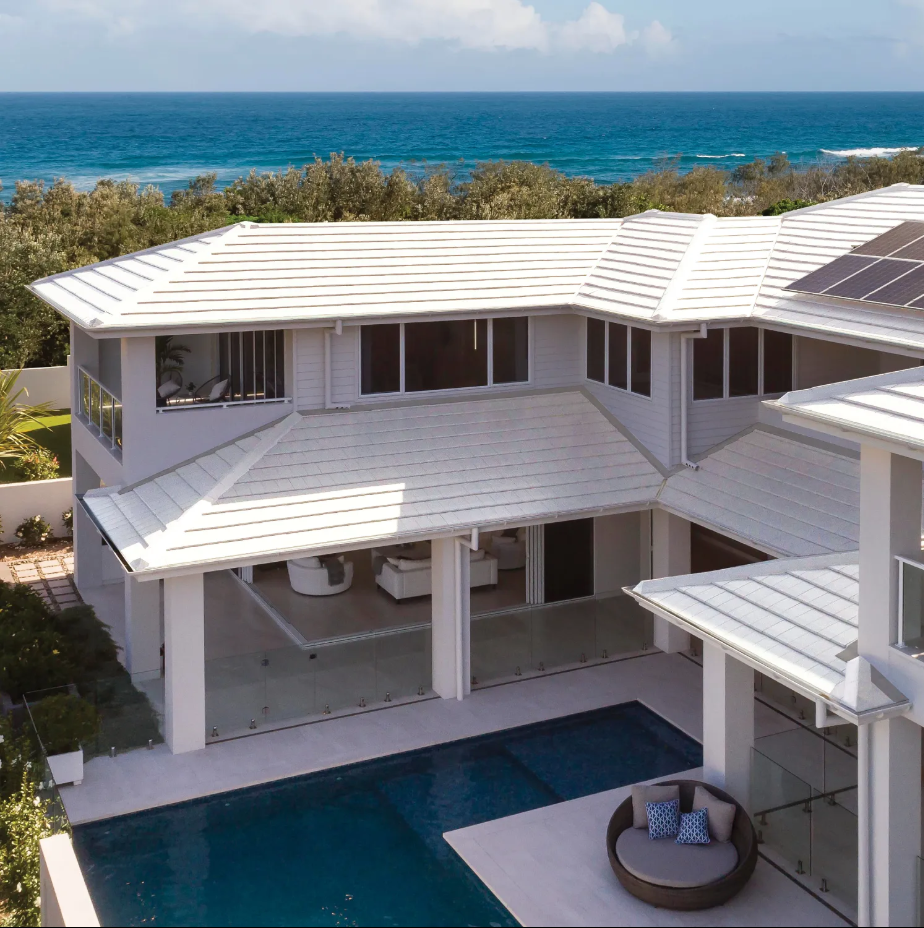 An Aerial View of a Large White House With a Swimming Pool — Mr Roof Tiles in Kingscliff, NSW