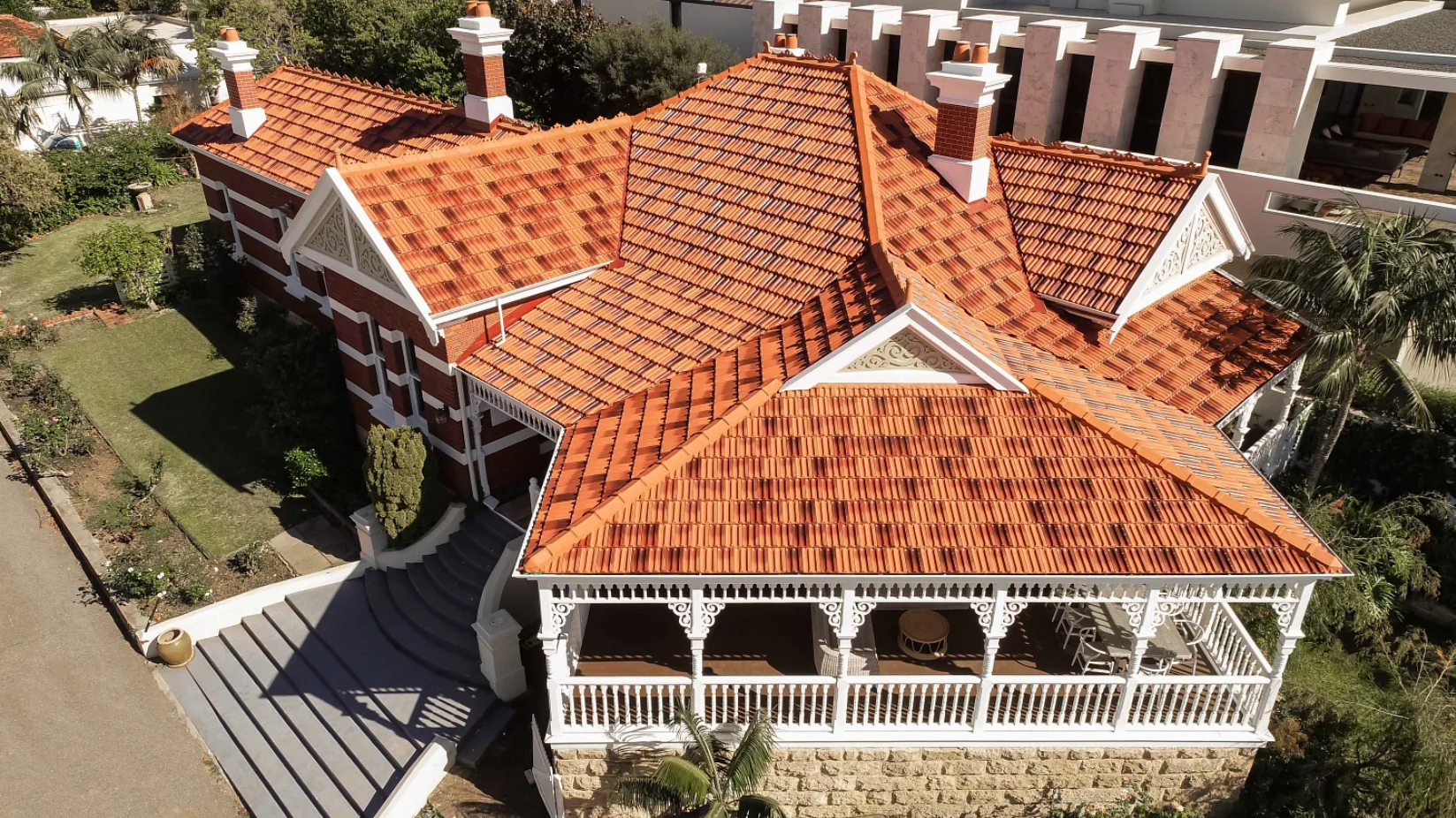 An Aerial View of a Large House With a Red Tiled Roof — Mr. Roof Tiles in Coffs Harbour, NSW