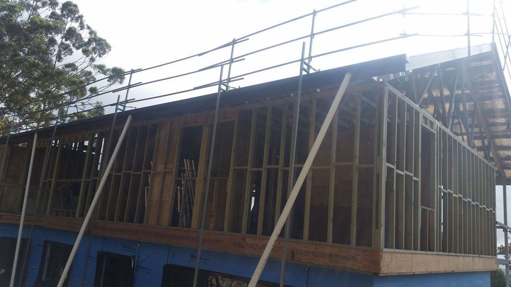A Building Under Construction With Scaffolding on the Roof — Mr. Roof Tiles in Kingscliff, NSW