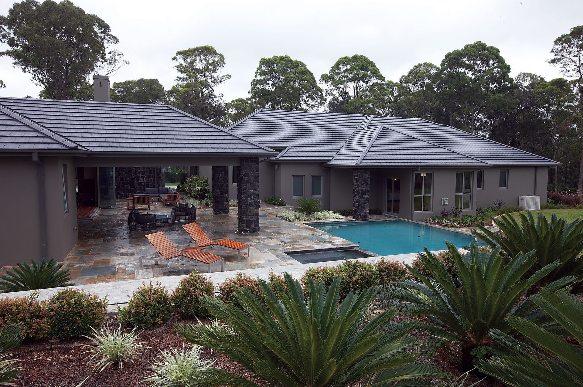 A Large House With a Swimming Pool in the Backyard — Mr Roof Tiles in Coffs Harbour, NSW