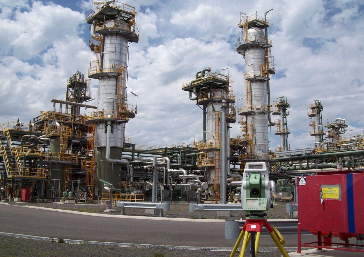 A Man Wearing A Hard Hat And Safety Vest Is Looking At A Blueprint – Warrnambool, VIC - Joseph Land Surveying