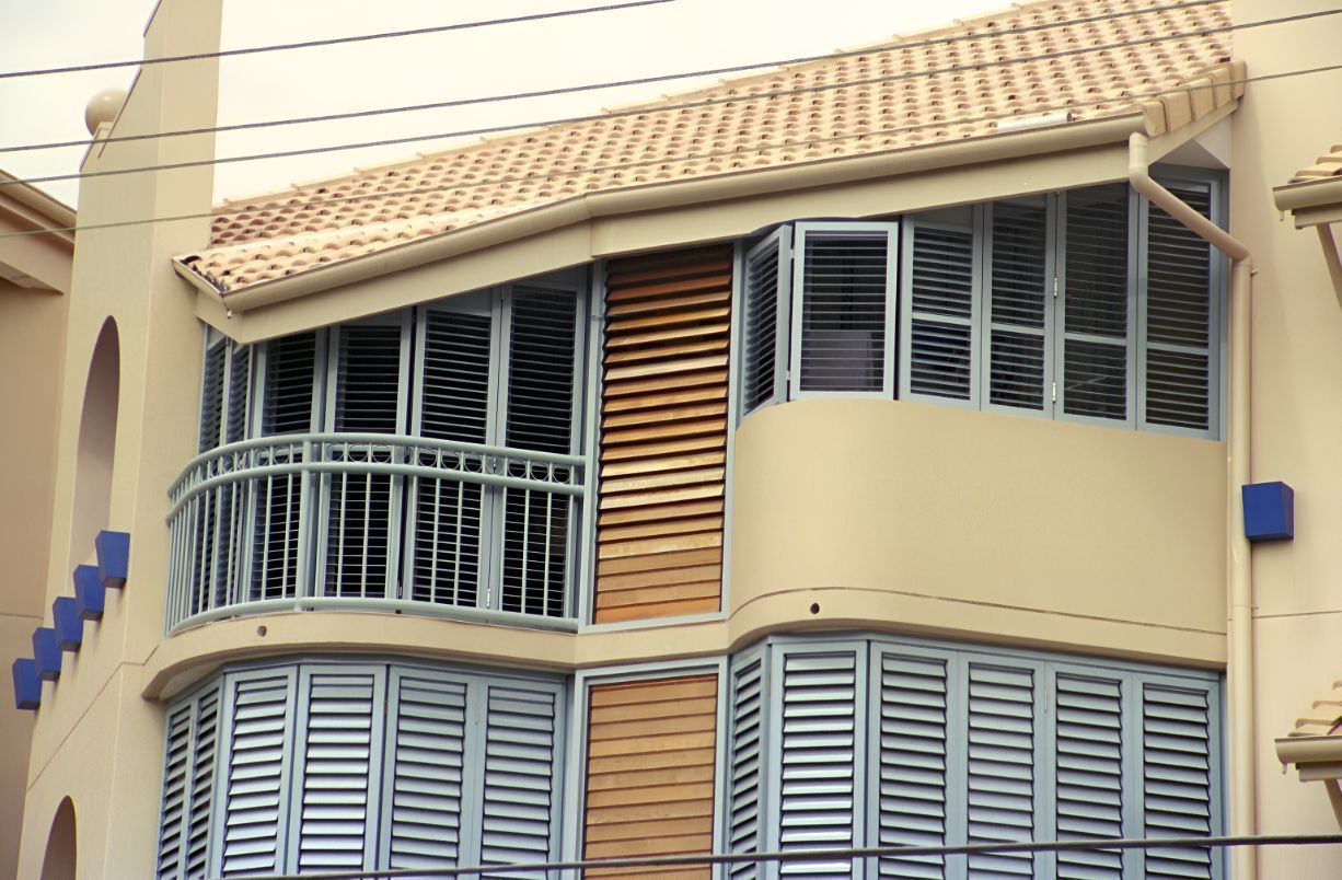 A Building With a Balcony and Shutters on It — South Burnett Garage Doors In Nanango, QLD
