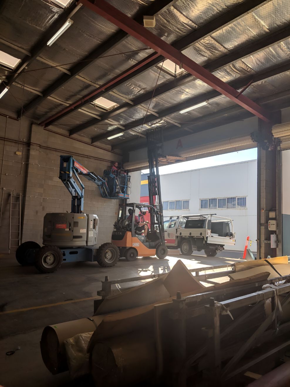 A Warehouse With a Forklift and a Crane in It β South Burnett Garage Doors In Kingaroy, QLD