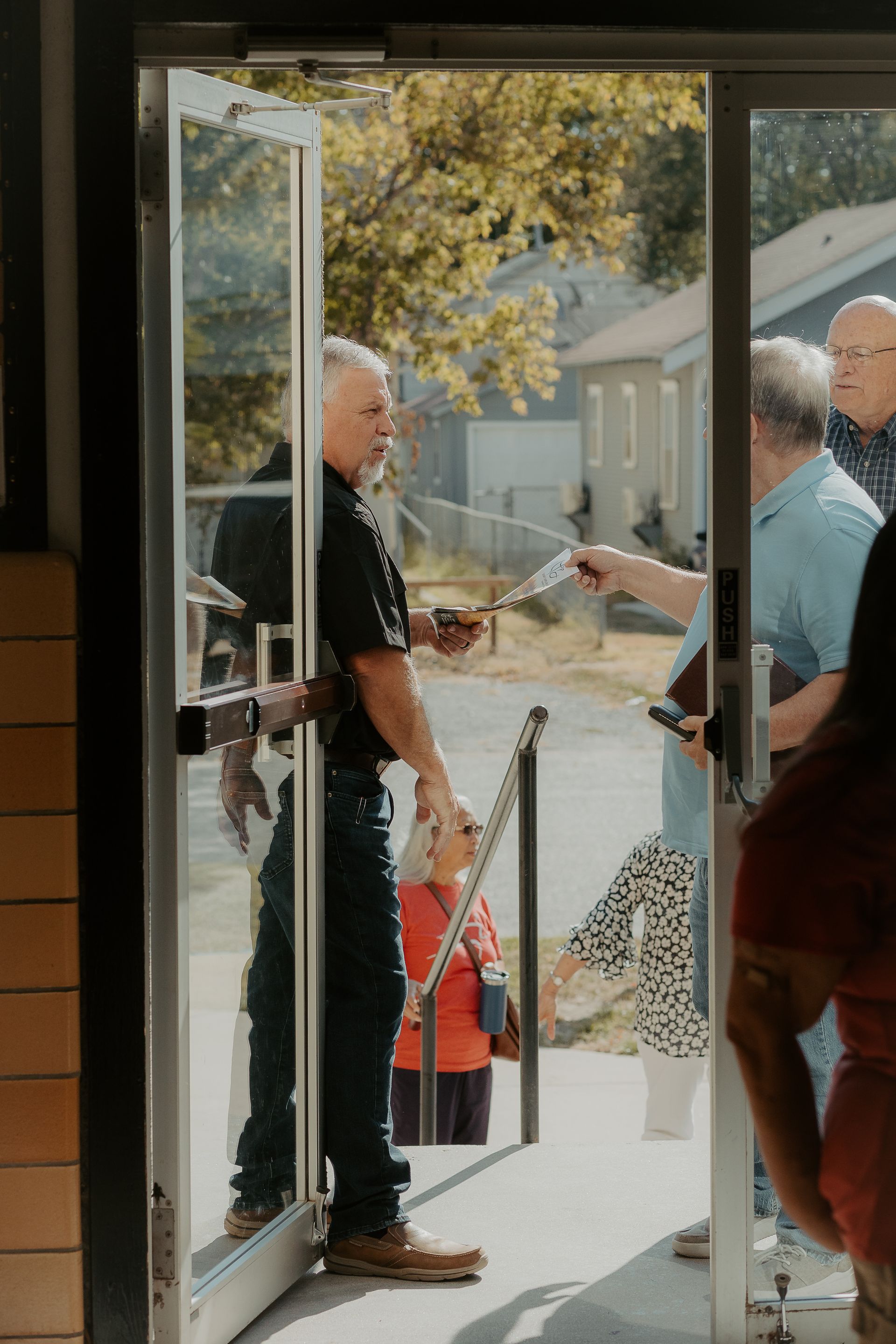 A group of people are standing in a doorway.