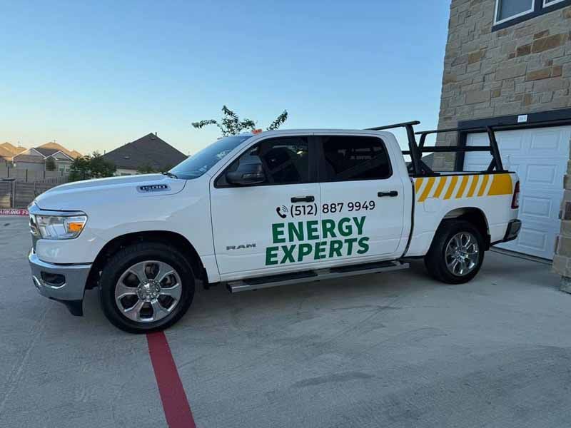 White Energy Experts pickup truck parked in a driveway beside a house