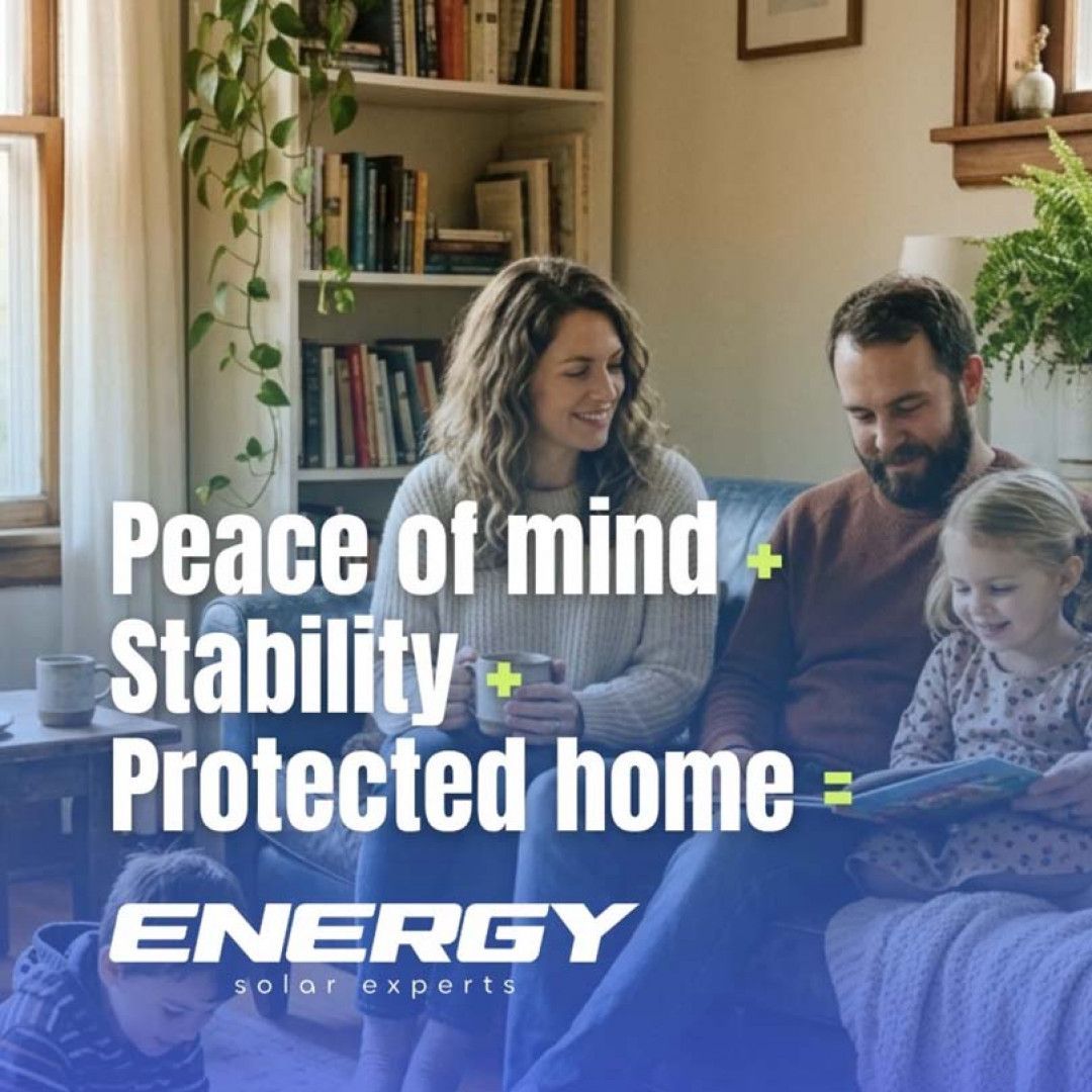 Family on a couch in a cozy living room with text: “Peace of mind + Stability + Protected home = ENERGY”