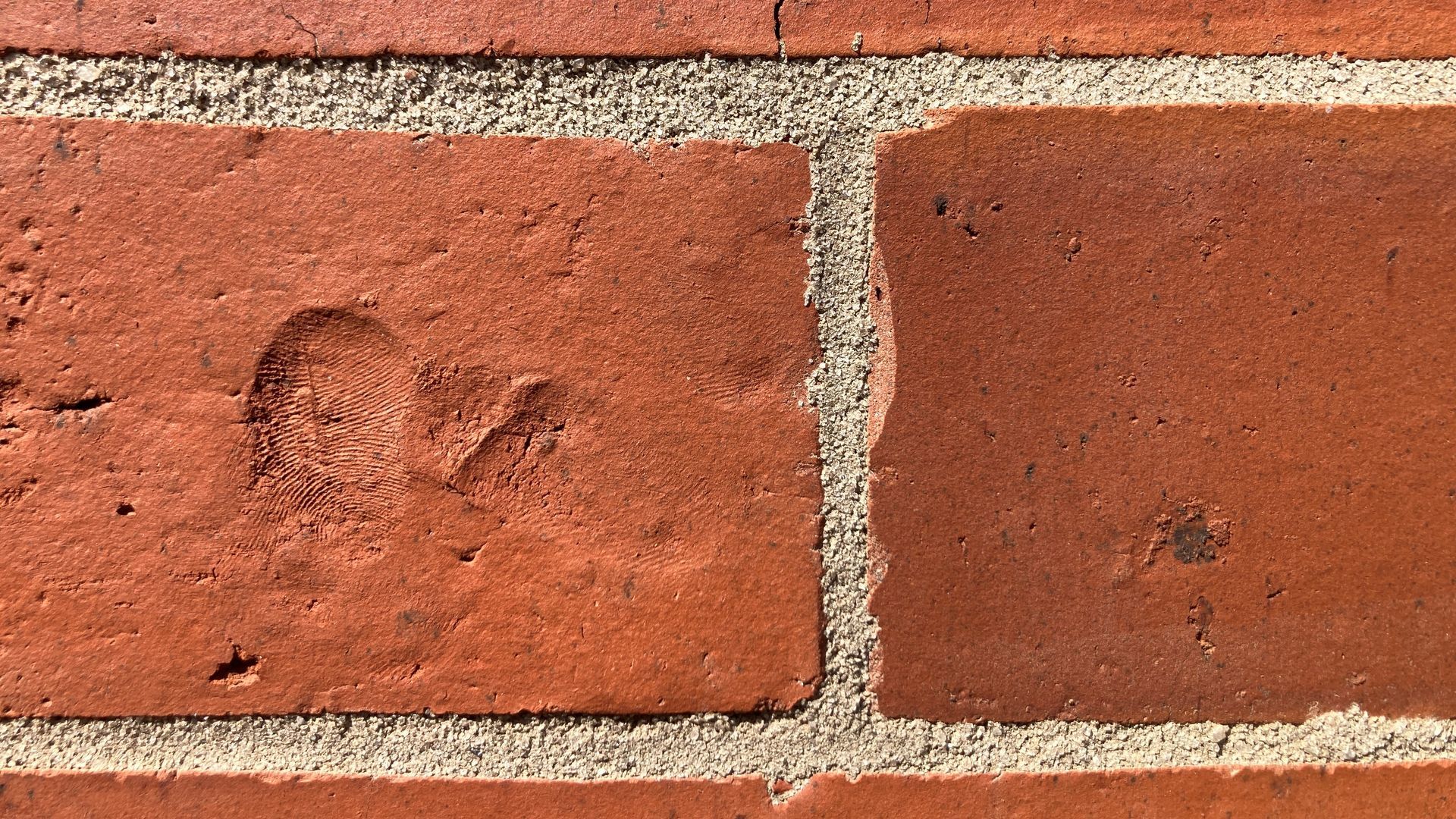 Thumbprints in bricks.