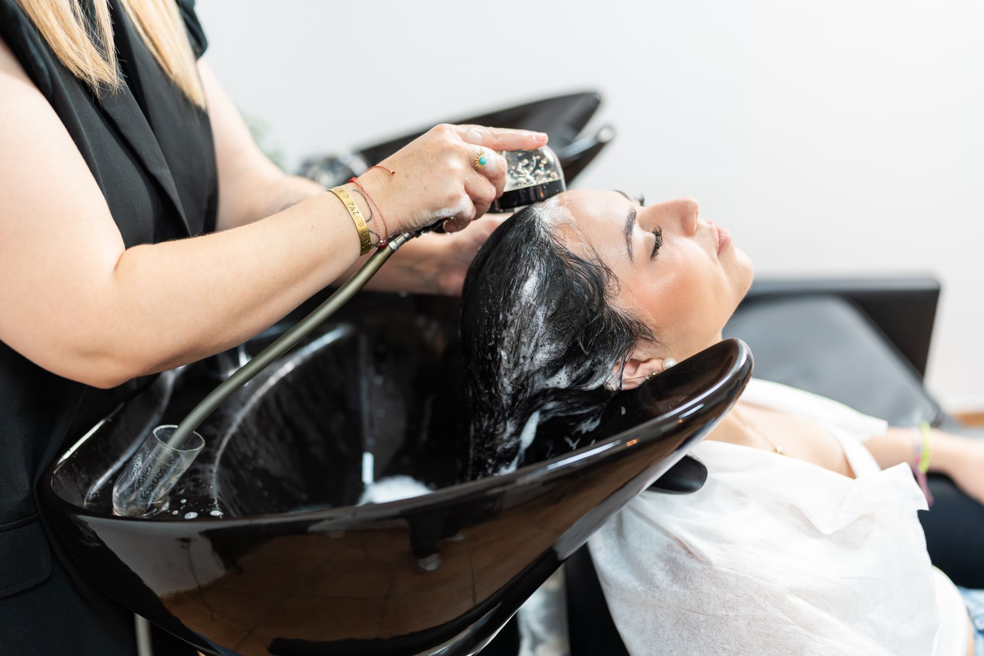 A woman is having her hair washed.