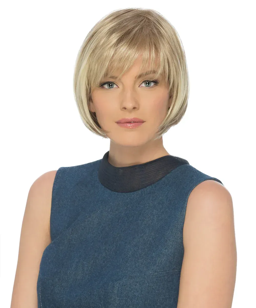 Blonde woman with a bob haircut, wearing a sleeveless blue top, looking forward.