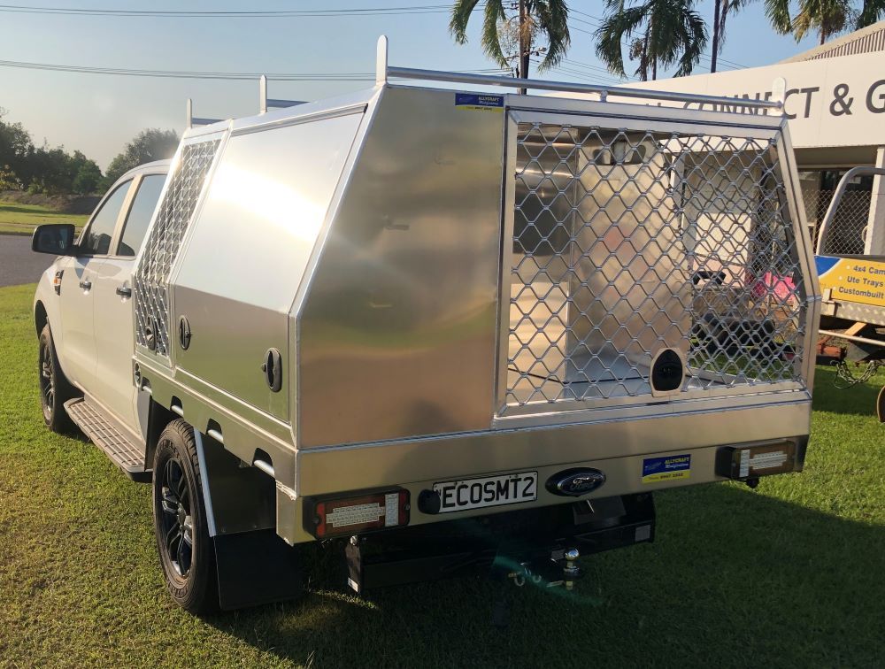 A Silver Truck With a Canopy is Parked on a Lush Green Field — Allycraft Modifications in Berrimah, NT