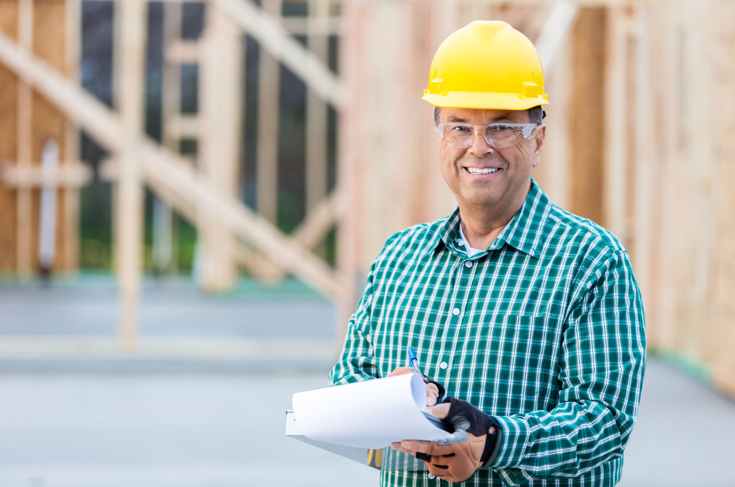 A group of construction workers are having a meeting on a construction site.