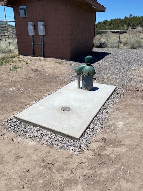A concrete platform with a green pipe on top of it