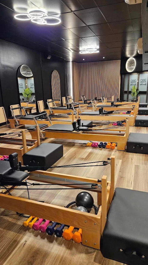 A Group Of People Are Doing Exercises With Dumbbells In A Gym — 360 Fitness Group in Gordonvale, QLD