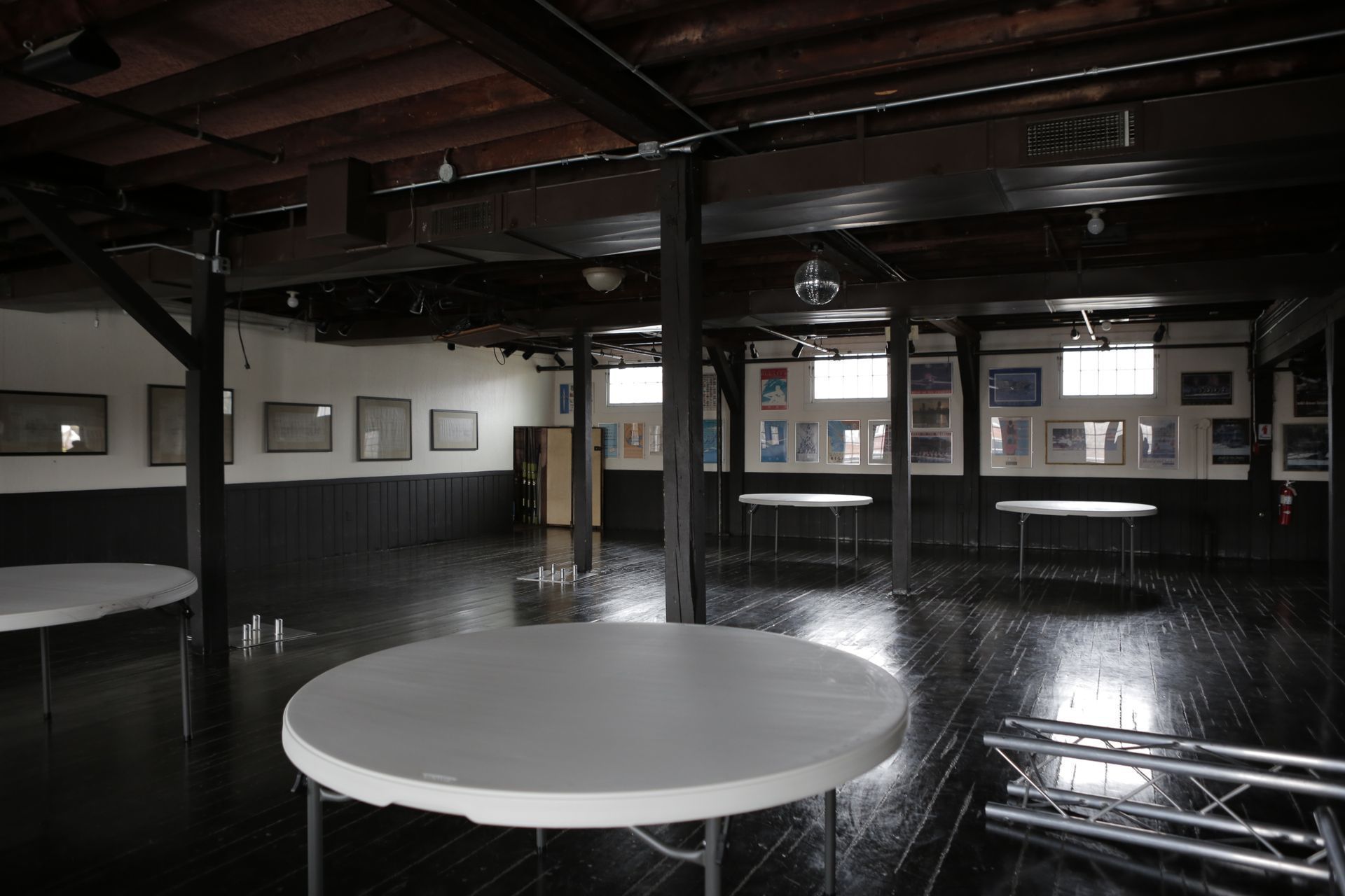 Harvard Boat Club empty room with round tables in the middle and pictures on wall