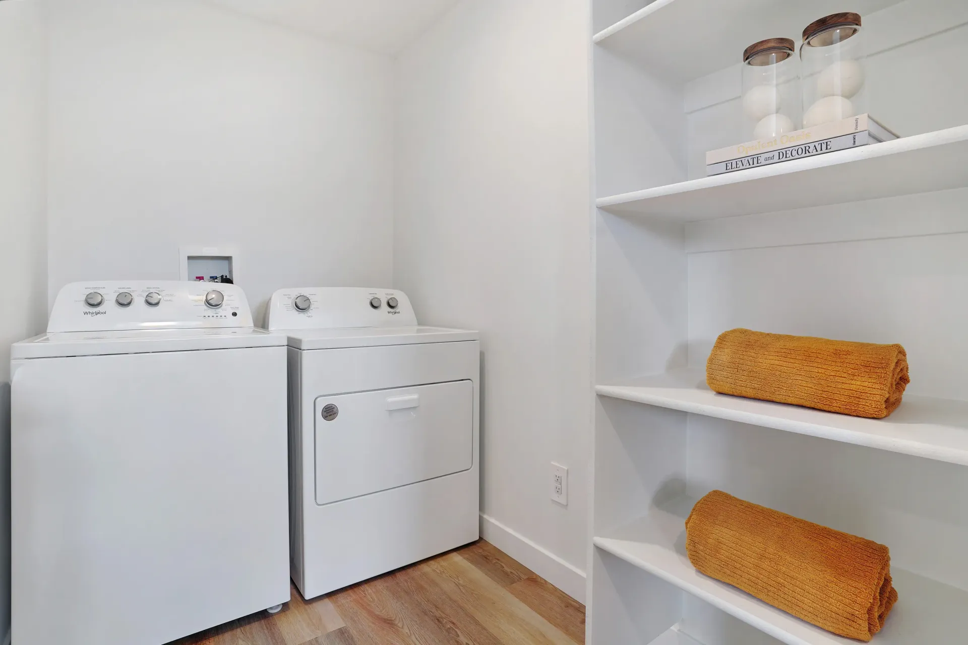 Washer and dryer with shelving unit in laundry room at Little Valley, offering  pet-friendly apartments in Magna, UT.