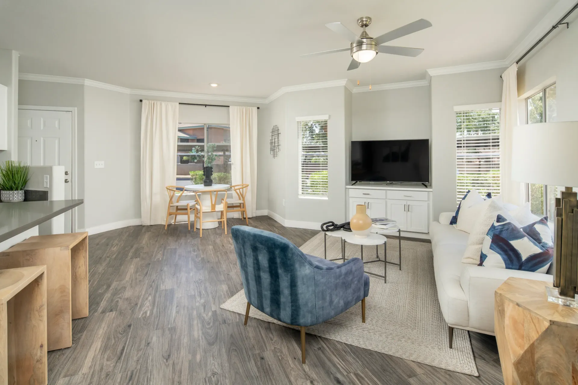 Living room and dining area with a couch, chairs, and a table.