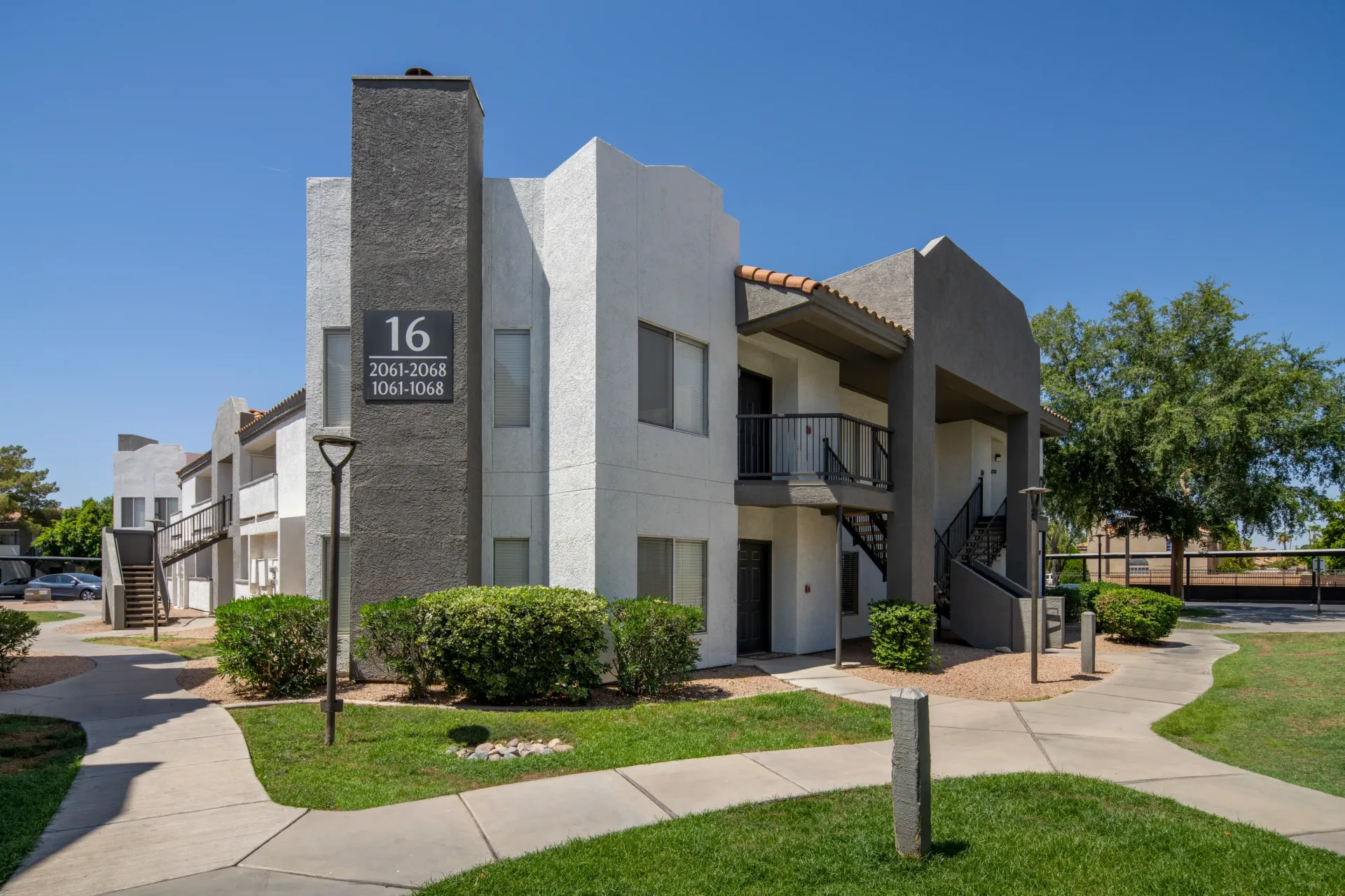 Exterior of apartment building with balconies and exterior staircases.