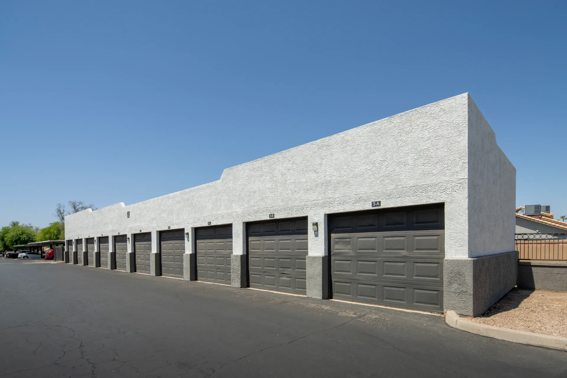 Row of garage doors with numbers above them.