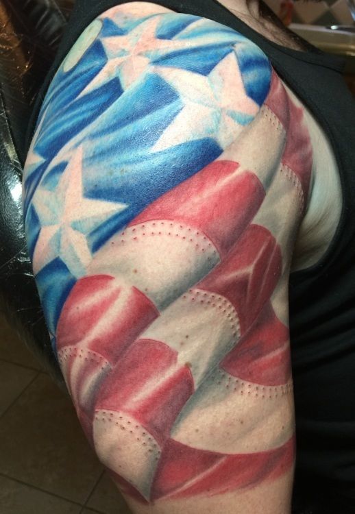 American flag tattoo on a person's upper arm, with blue stars and red and white stripes.